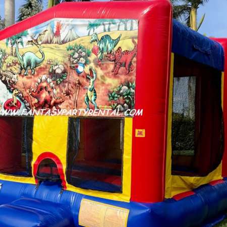 Dinosaur primary colors bounce house with basketball hoop.