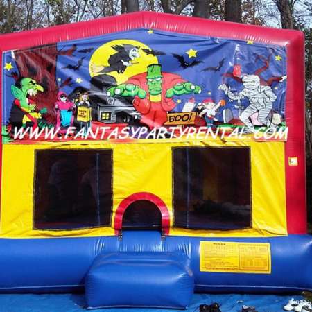 Halooween primary colors bounce house with basketball hoop.