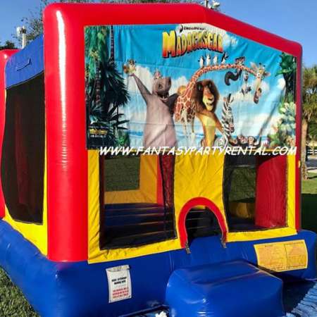 Madagascar primary colors bounce house with basketball hoop.