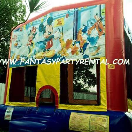 Mickey and Friends primary colors bounce house with basketball hoop.