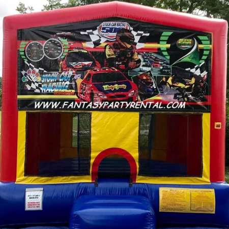 Racing Cars primary colors bounce house with basketball hoop.