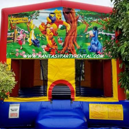 Winnie The Pooh primary colors bounce house with basketball hoop.
