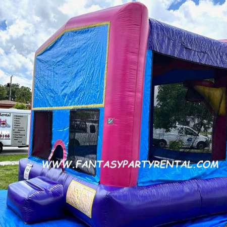 Pink, purple and blue standard size bounce house with basketball hoop